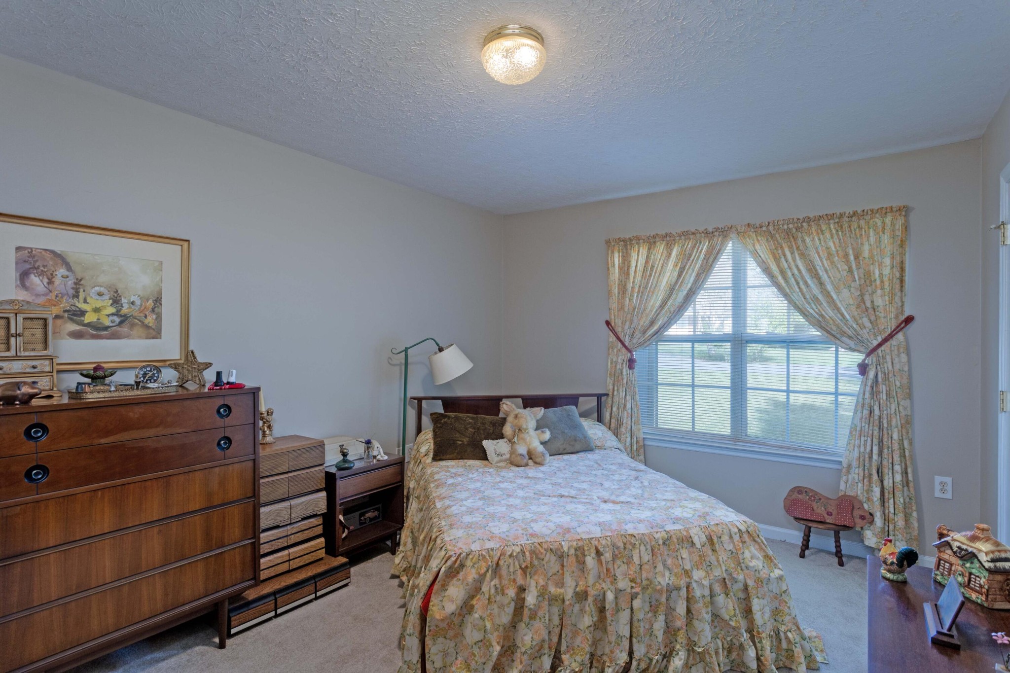 201 Broyles Road Spring City, TN 37381 - Photo 22 of 34 a bedroom with a bed and a dresser next to a window