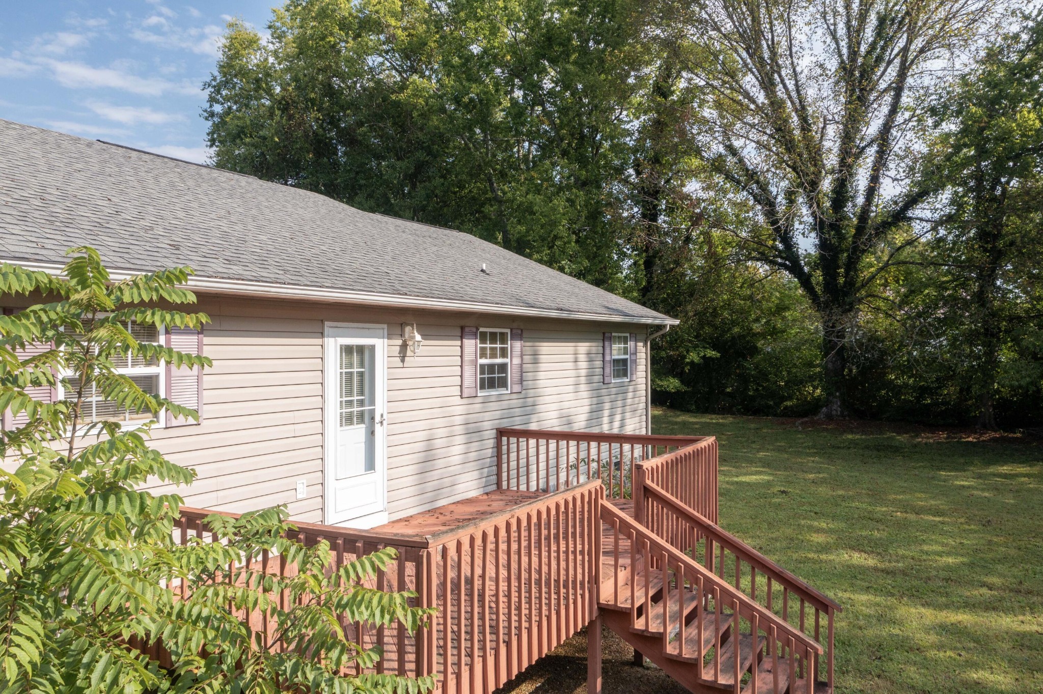 201 Broyles Road Spring City, TN 37381 - Photo 27 of 34 a view of a house with a wooden deck