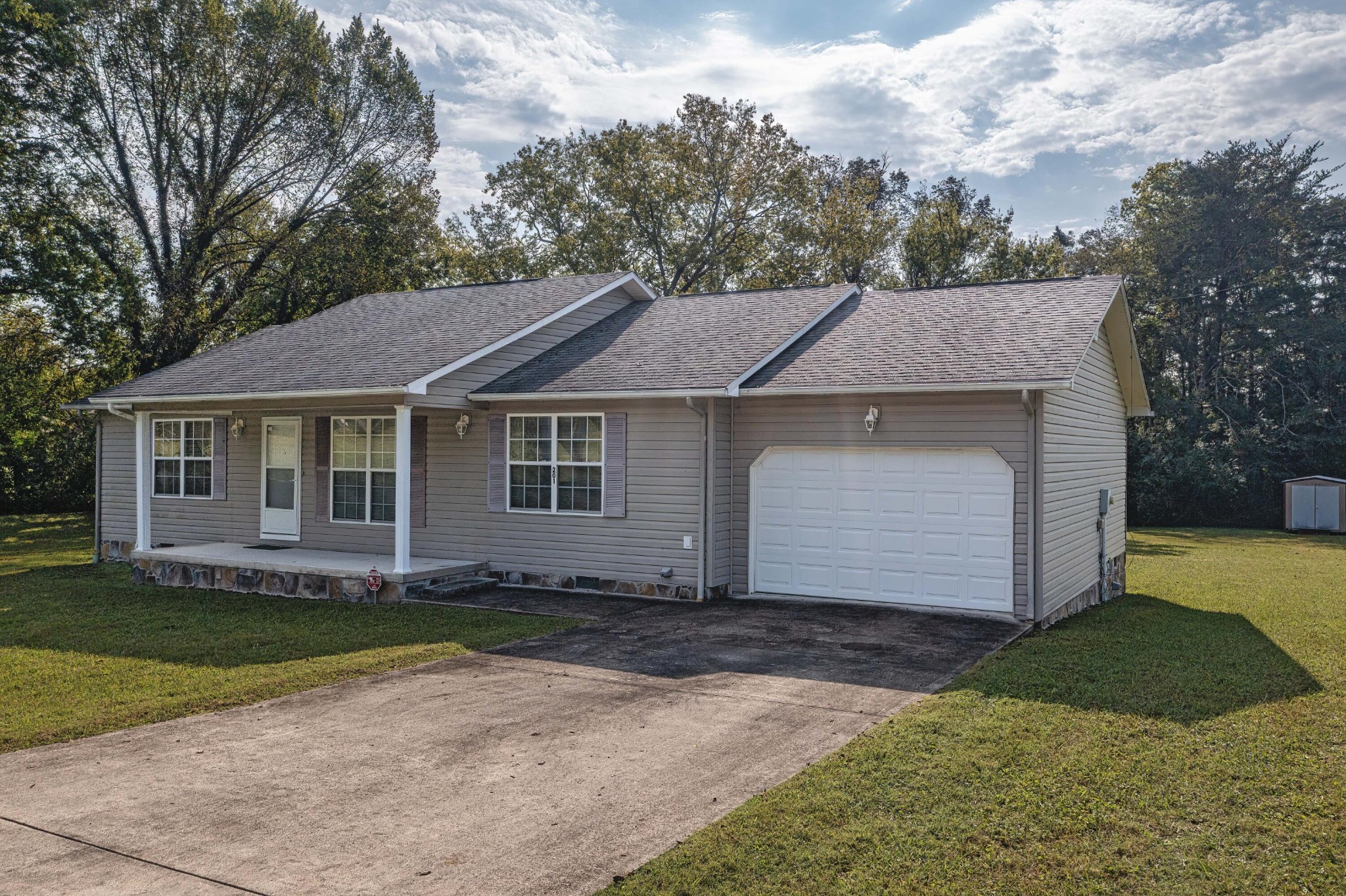 201 Broyles Road Spring City, TN 37381 - Photo 3 of 34 a front view of a house with a garden
