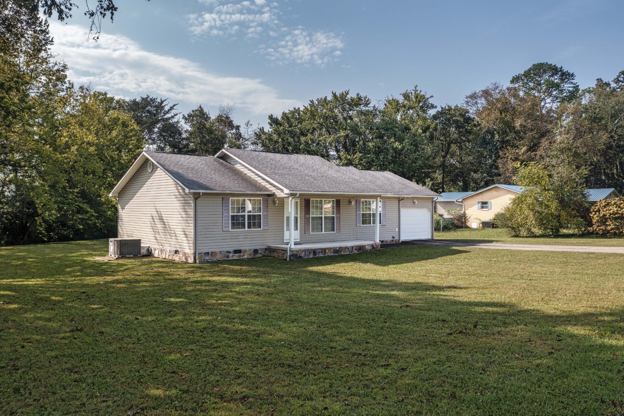 201 Broyles Road Spring City, TN 37381 - Photo 4 of 34 a front view of a house with a garden