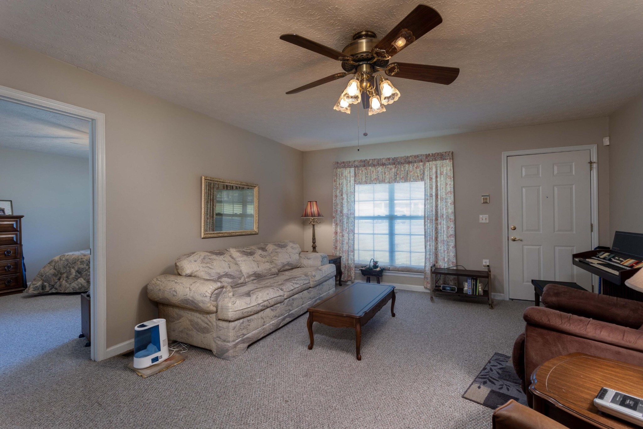 201 Broyles Road Spring City, TN 37381 - Photo 8 of 34 a living room with furniture and a chandelier