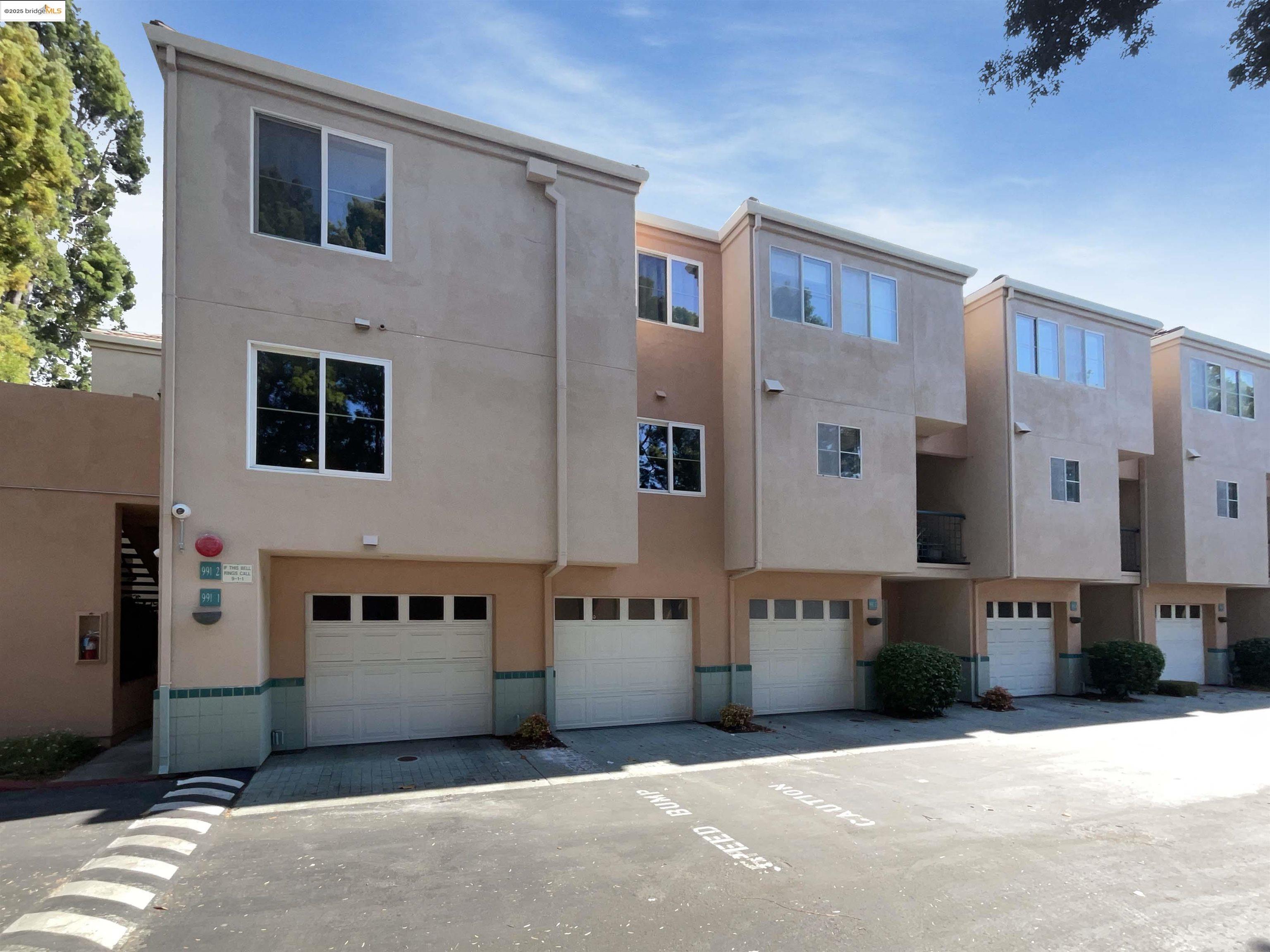 991 Asilomar Terrace, Unit 1 Sunnyvale, CA 94086 - Photo 1 of 20 View of building exterior with an attached garage