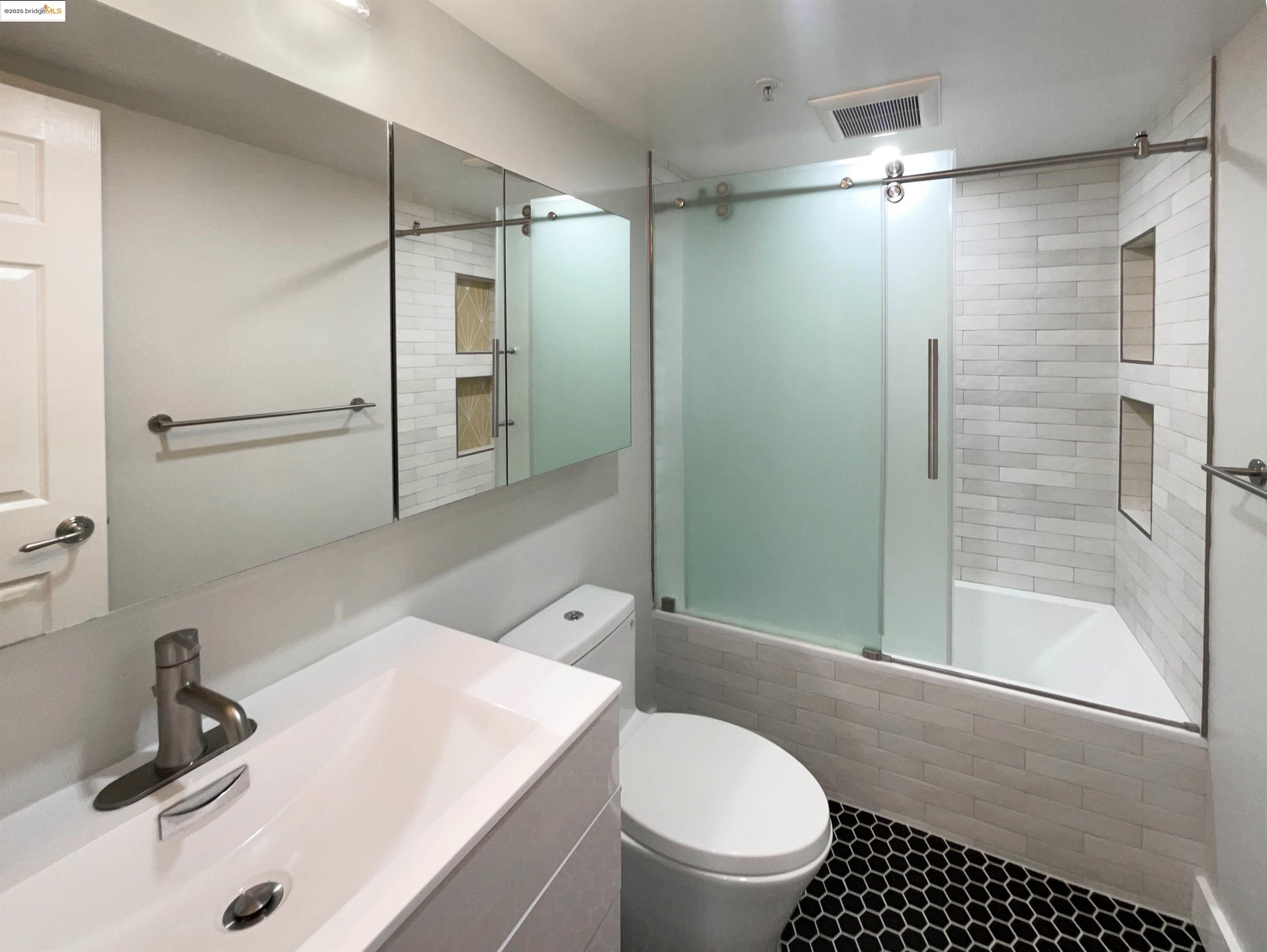 991 Asilomar Terrace, Unit 1 Sunnyvale, CA 94086 - Photo 16 of 20 Bathroom featuring a tile shower and vanity
