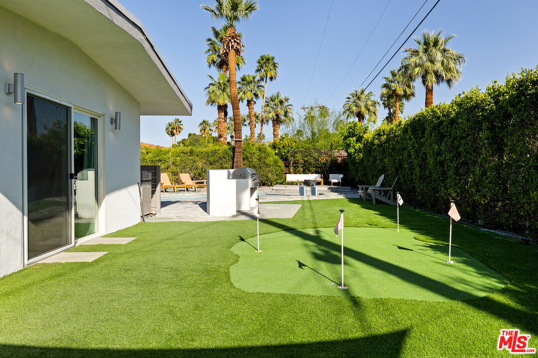 74085 Setting Sun Trail Palm Desert, CA 92260 - Photo 39 of 57 a view of a swimming pool with a garden