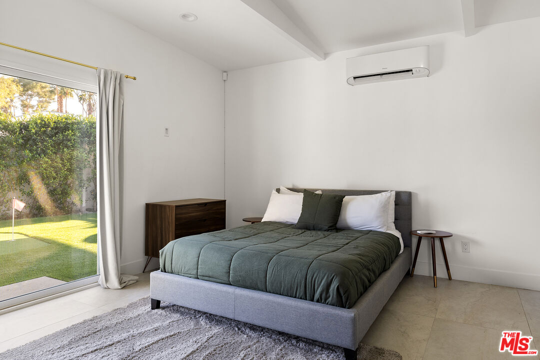 74085 Setting Sun Trail Palm Desert, CA 92260 - Photo 43 of 57 a bedroom with a large bed and a window