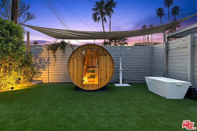 a view of a porch with furniture and floor to ceiling window