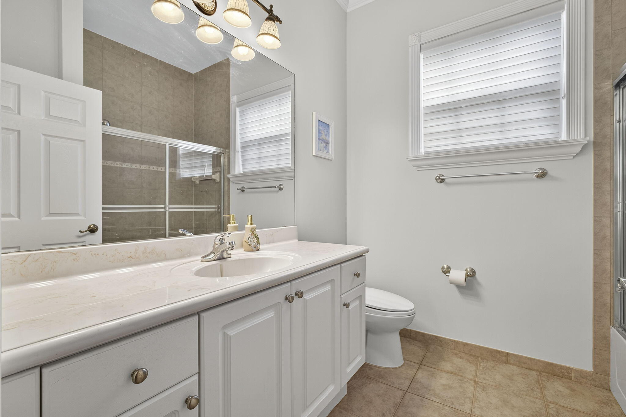 129 Via Bosque Jupiter, FL 33458 - Photo 22 of 92 a bathroom with a sink a toilet and a mirror