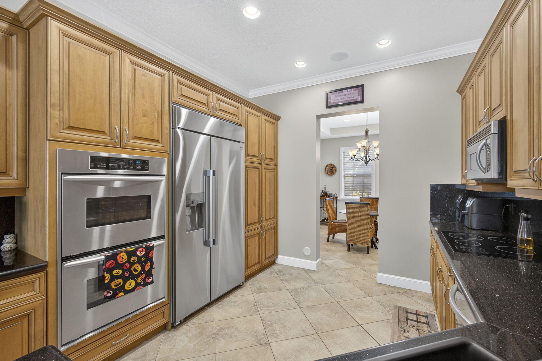 129 Via Bosque Jupiter, FL 33458 - Photo 27 of 92 a kitchen with stainless steel appliances granite countertop a refrigerator and a stove