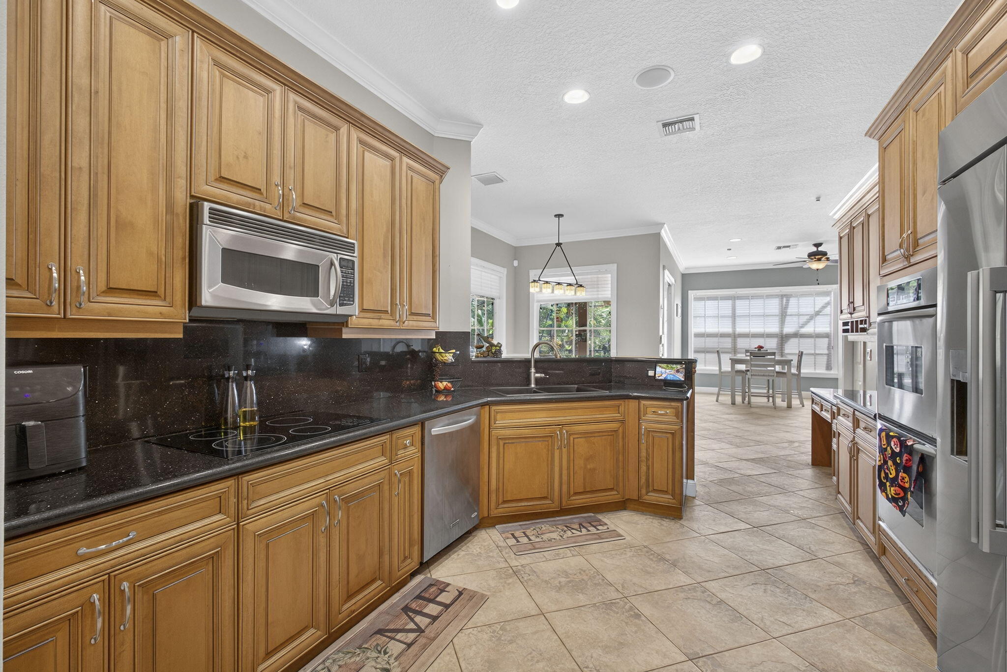 129 Via Bosque Jupiter, FL 33458 - Photo 35 of 92 a kitchen with stainless steel appliances granite countertop a sink and cabinets