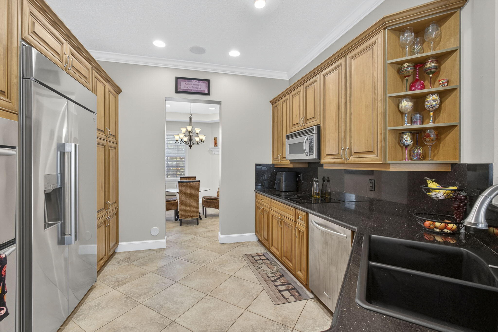 129 Via Bosque Jupiter, FL 33458 - Photo 36 of 92 a kitchen with stainless steel appliances granite countertop a refrigerator and a sink
