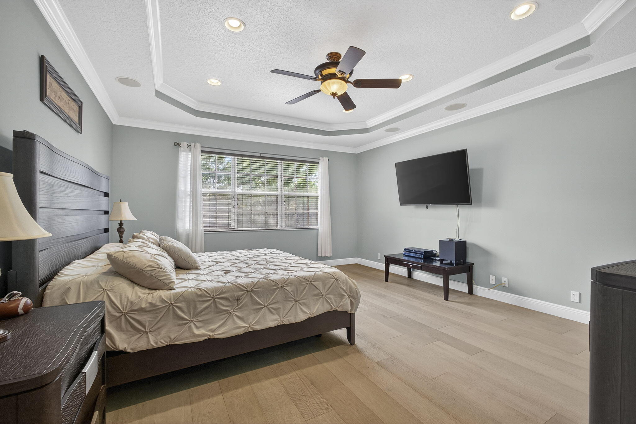 129 Via Bosque Jupiter, FL 33458 - Photo 60 of 92 a bedroom with a bed and a flat screen tv