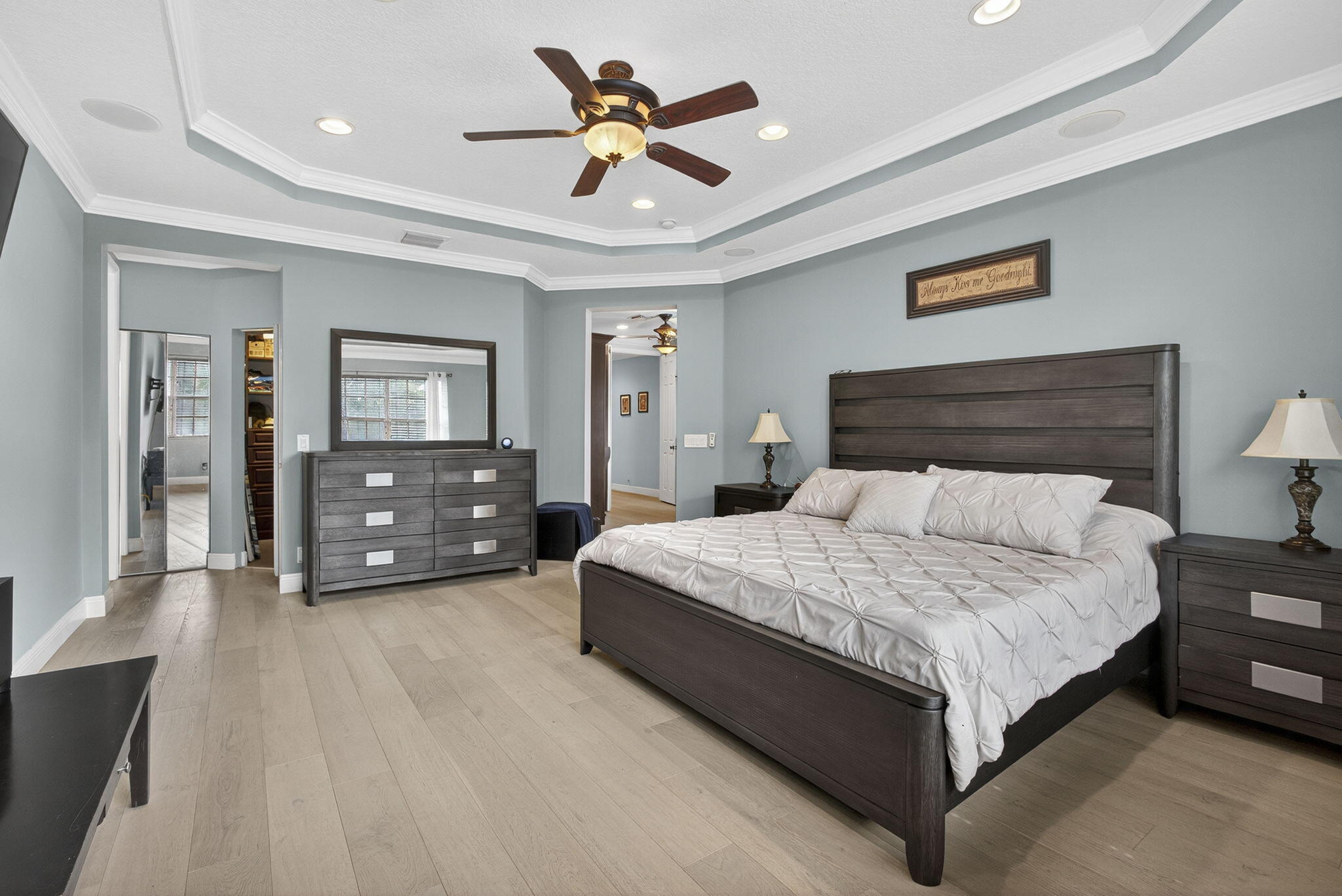 129 Via Bosque Jupiter, FL 33458 - Photo 63 of 92 a bedroom with a bed and a chandelier