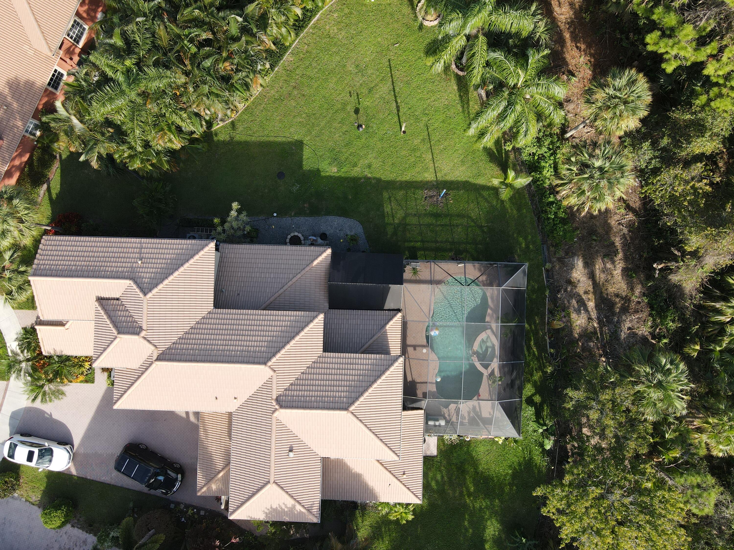 129 Via Bosque Jupiter, FL 33458 - Photo 8 of 92 an aerial view of a house with swimming pool and garden