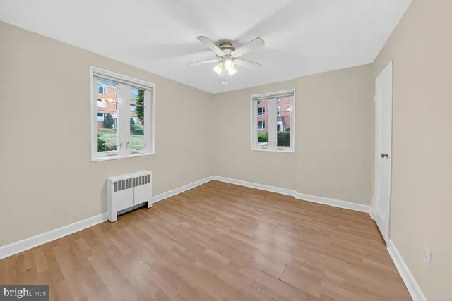 wooden floor in an empty room with a window