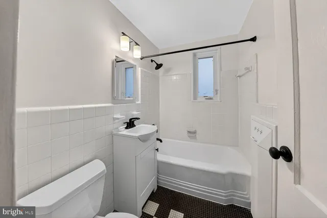 a bathroom with a shower a bathtub and a toilet