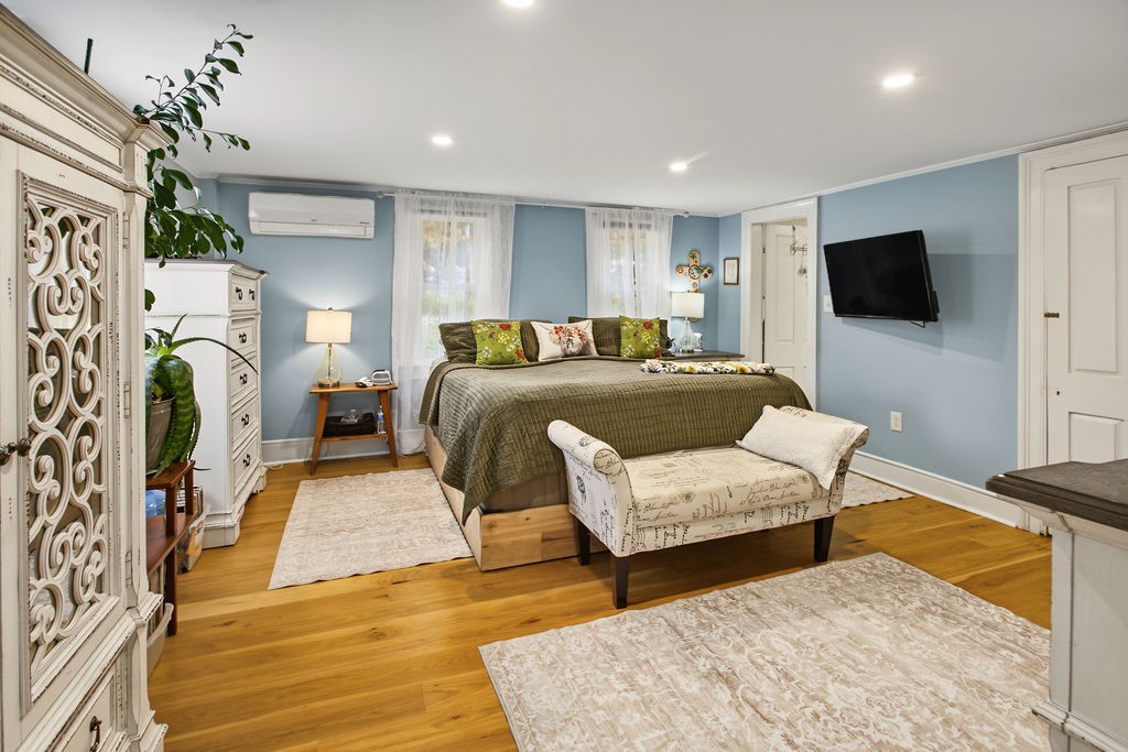 1668 Vandervort Hill Road Unadilla, NY 13849 - Photo 17 of 50 Rich hardwood floors and classic crown molding elevate this serene bedroom retreat.