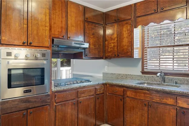 a kitchen with stainless steel appliances wooden cabinets and a granite counter tops