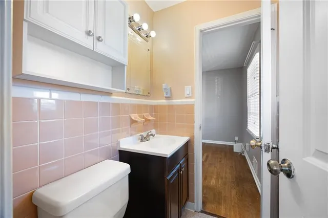 a bathroom with a sink a toilet and a mirror