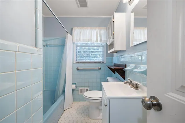 a bathroom with a toilet a sink and a shower