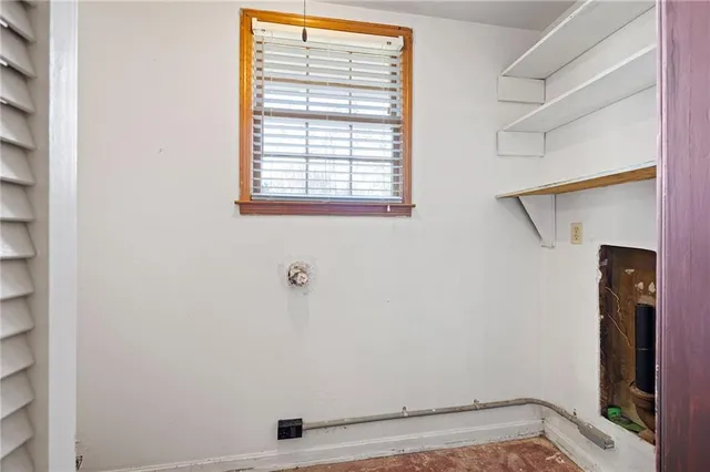 a view of storage and utility room with a window