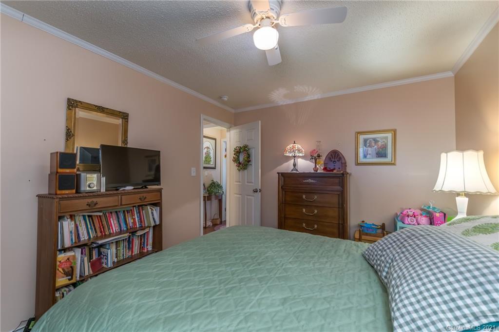 305 Cedar Tree Ln Mill Spring Mill Spring, NC 28756 - Photo 22 of 37 a bedroom with a bed and a flat screen tv