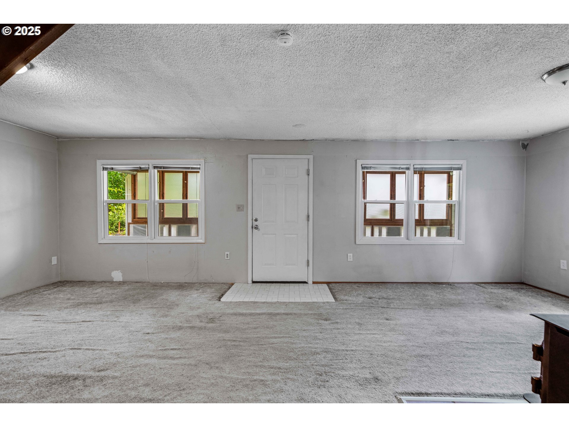 10303 Southeast Bull Run Road Sandy, OR 97055 - Photo 6 of 48 an empty room with wooden floor and windows