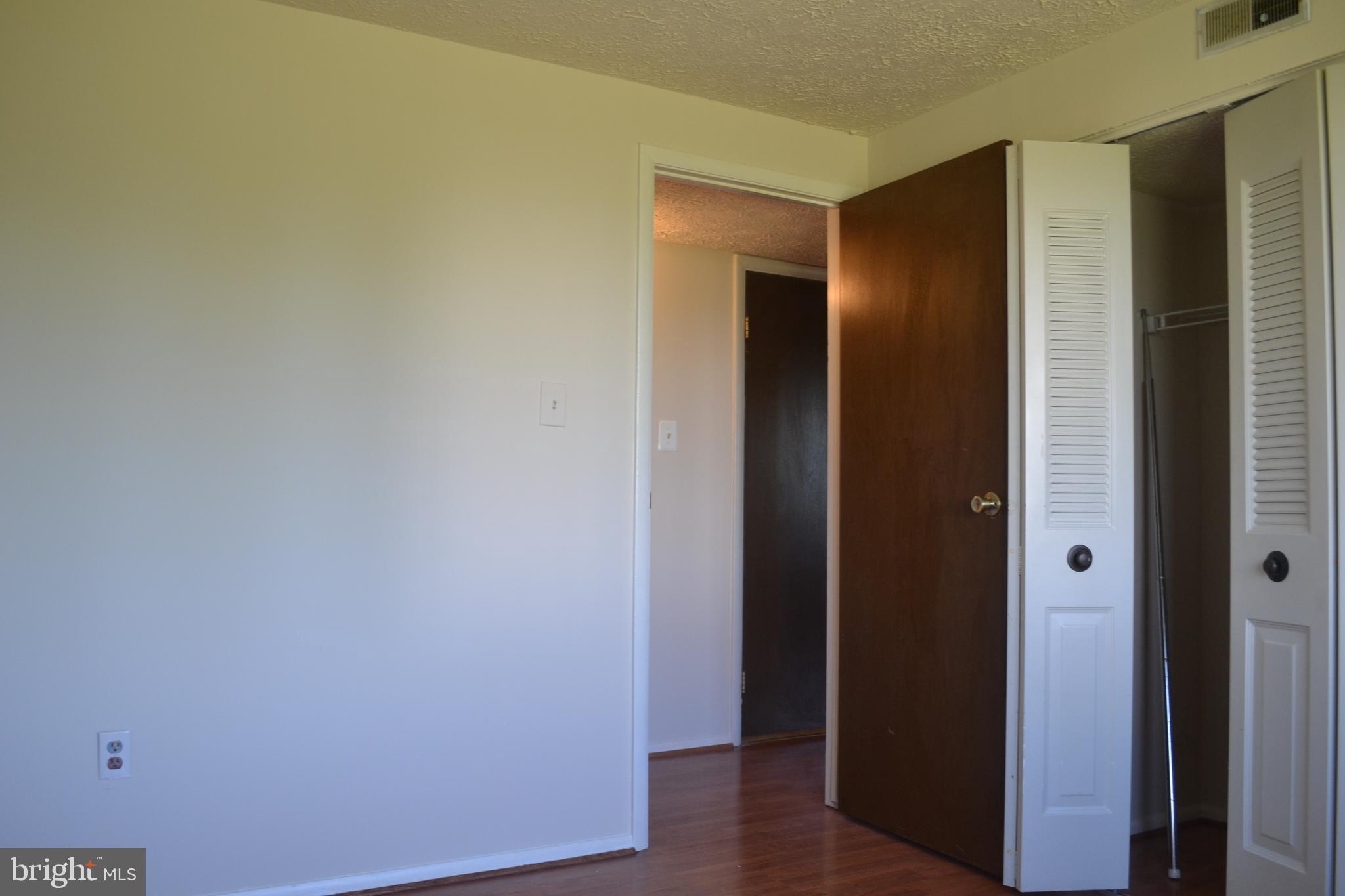 800 L Heather Ridge Drive, Unit 19L Frederick, MD 21702 - Photo 8 of 10 an empty room with wooden floor and closet