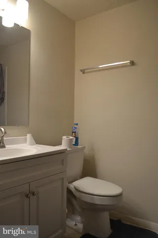 a bathroom with a sink a toilet and mirror