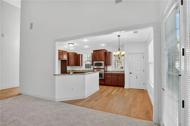 a kitchen with stainless steel appliances a refrigerator and a kitchen island