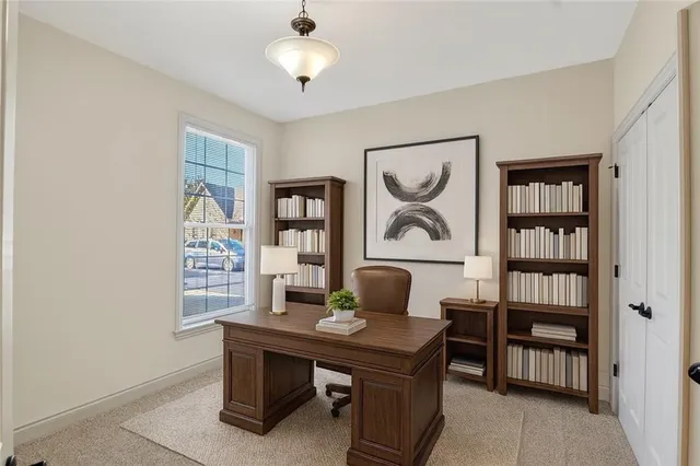a view of a workspace with furniture and window