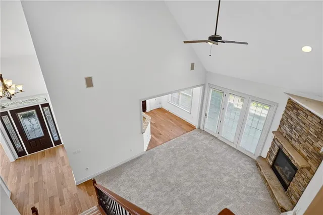 a view of a livingroom with wooden floor and staircase