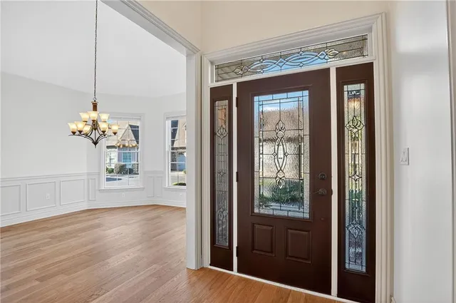 a view of an entryway with wooden floor