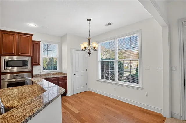 a kitchen with kitchen island a counter top space appliances and a window
