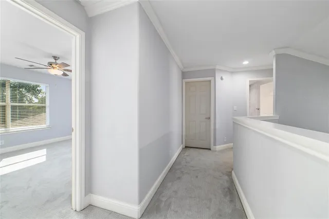 a view of hallway with window and entryway