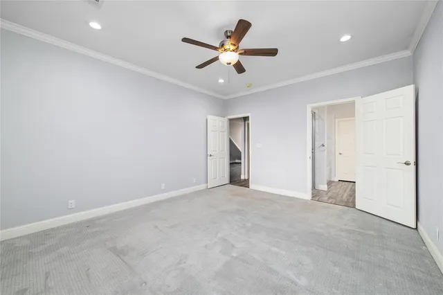 an empty room with closet and ceiling fan