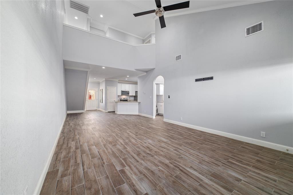 3002 Waterstone Way Brownwood, TX 76801 - Photo 6 of 35 an empty room with wooden floor a ceiling fan and windows