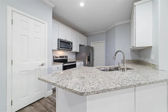 a kitchen with granite countertop a sink and a stove