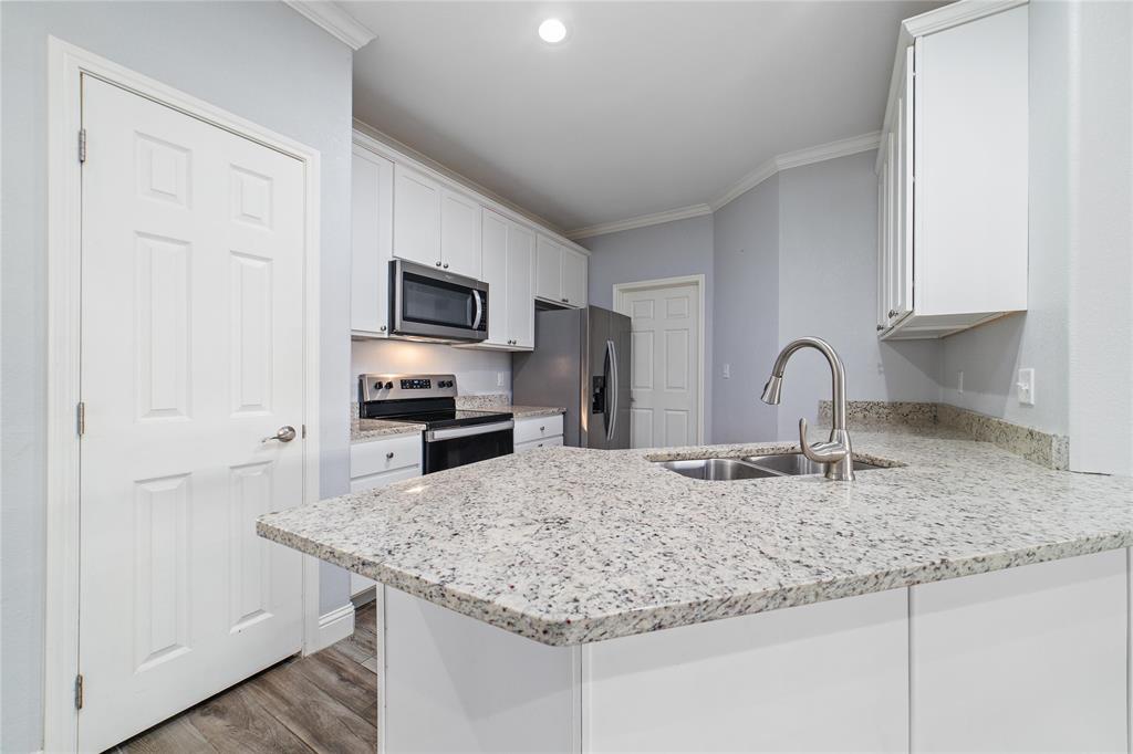 3002 Waterstone Way Brownwood, TX 76801 - Photo 7 of 35 a kitchen with granite countertop a sink and a stove