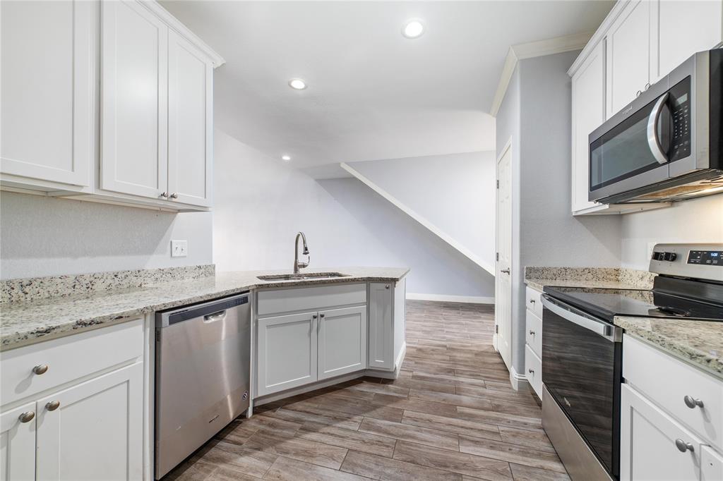 3002 Waterstone Way Brownwood, TX 76801 - Photo 8 of 35 a kitchen with stainless steel appliances granite countertop a sink and a stove top oven