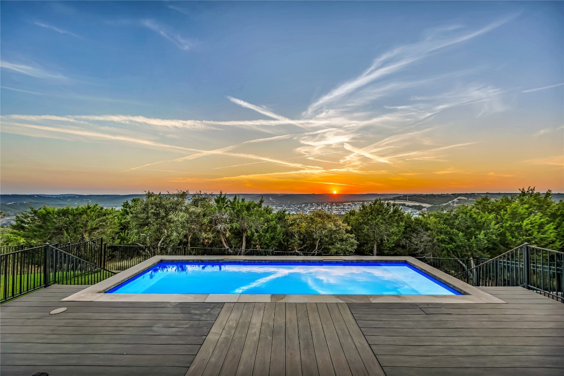 1745 Liguria Court Leander, TX 78641 - Photo 1 of 1 Pool at dusk featuring greenbelt and. hill. country views!
