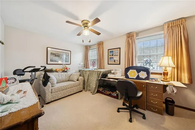 a view of a livingroom with workspace and a couch