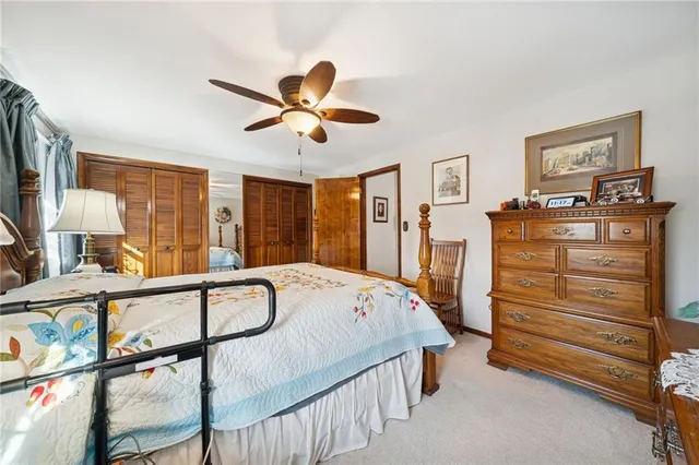 a bedroom with a bed a dresser next to a window