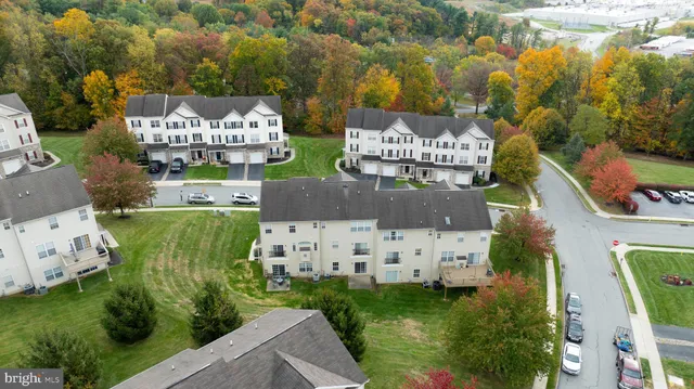 aerial view of a house with garden space and street view