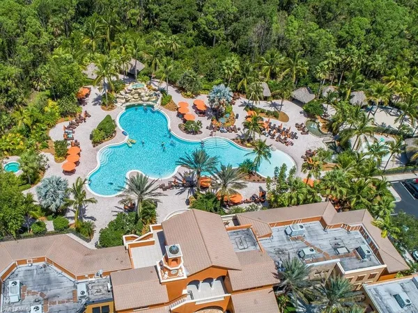 a front view of a house with swimming pool having outdoor seating