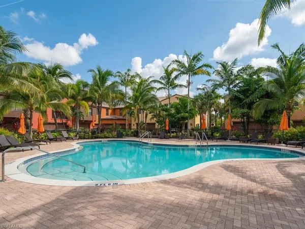 a view of multiple houses with palm trees