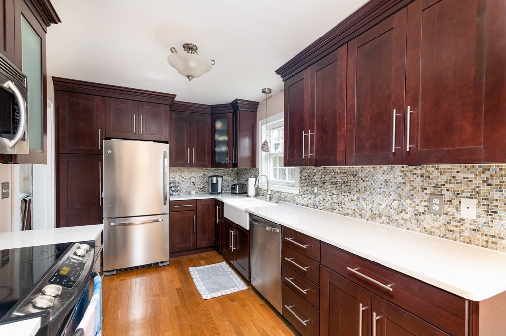 78 Cedarcliff Road Braintree, MA 02184 - Photo 8 of 39 a kitchen with wooden cabinets and stainless steel appliances