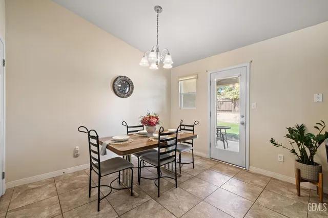 a view of a dining room with furniture and a chandelier