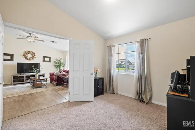 a view of a livingroom with workspace and a window