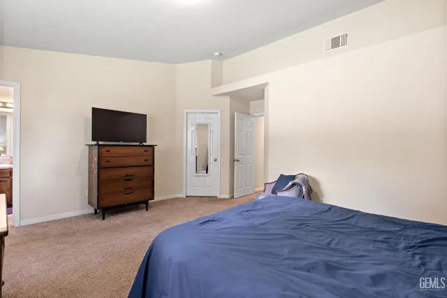 a bedroom with a bed and a television