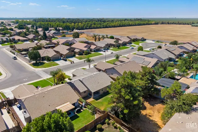 an aerial view of a city with lots of residential buildings and lake view